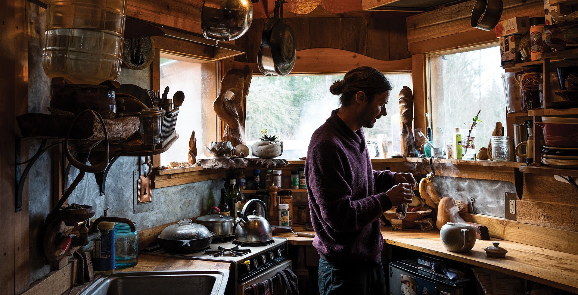 Travis brews a pot of tea in the kitchen of the Leafspring, a tiny house he calls home. Photo: Ian Terry