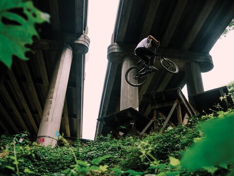 As the first urban mountain bike park in the United States, Colonnade opened the door on an entirely new realm for the sport—and thanks to the then-fledgling Evergreen Mountain Bike Alliance, set the bar for what community-based advocacy could accomplish. Carson Storch styles a 360 while demonstrating proper under-Interstate form.