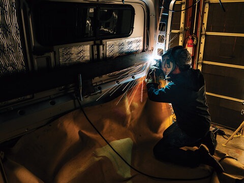 From routing and cutting to gluing and welding, the list of tools required for a full-scale buildout is not short. Tyler Earnheart puts in some late night hours on Jill and Bryn's van.